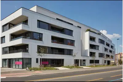 a white building on the side of a street at Apartmantplus02 in Prague