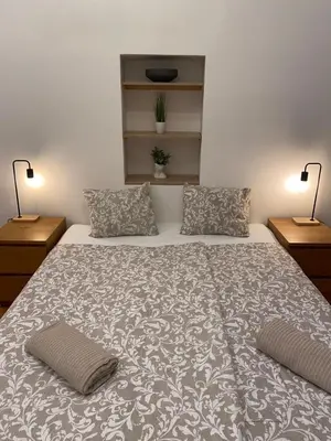 a bedroom with a large bed with two pillows at Stylish studio apartment by Namesti Miru in Prague