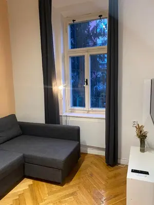 a living room with a couch and a window at Stylish studio apartment by Namesti Miru in Prague