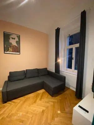 a living room with a couch and a window at Stylish studio apartment by Namesti Miru in Prague