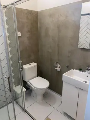 a bathroom with a toilet and a sink at Stylish studio apartment by Namesti Miru in Prague