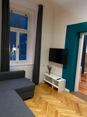 a living room with a couch and a flat screen tv at Stylish studio apartment by Namesti Miru in Prague