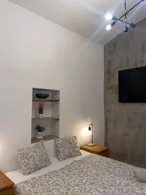 a bedroom with a bed and a flat screen tv at Stylish studio apartment by Namesti Miru in Prague
