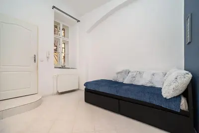 a bedroom with a bed and a tv in it at Cosy, retro-styled flat in beautiful Zizkov in Prague