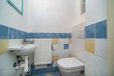 a bathroom with a toilet and a sink at Cosy, retro-styled flat in beautiful Zizkov in Prague