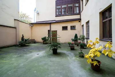 a courtyard with potted plants in front of a building at Cosy, retro-styled flat in beautiful Zizkov in Prague