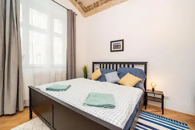a bedroom with a bed with blue towels on it at Cosy, retro-styled flat in beautiful Zizkov in Prague