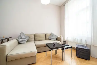 a living room with a couch and a table at Cozy and sunny apartment in uptown in Prague