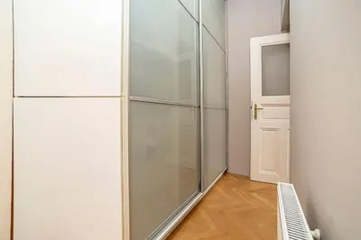 a glass closet with a door in a room at Cozy and sunny apartment in uptown in Prague