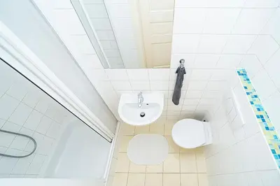 a white bathroom with a sink and a toilet at Cozy and sunny apartment in uptown in Prague