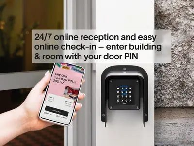 a person holding a cell phone in front of a door at Numa Prague Poise in Prague