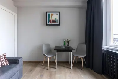 a living room with a table and two chairs at Numa Prague Poise in Prague