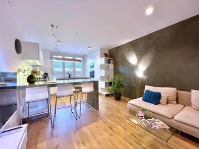 a kitchen and living room with a couch and a table at Jana's apartment, free parking in Prague
