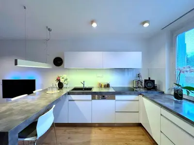 a kitchen with white cabinets and a counter top at Jana's apartment, free parking in Prague