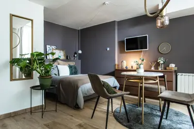 a bedroom with a bed and a table and chairs at Cozy modern studio in Prague's absolute center in Prague