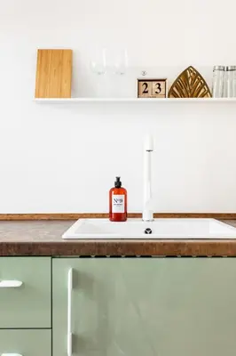 a bathroom sink with a bottle of soap on it at Cozy modern studio in Prague's absolute center in Prague