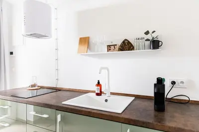 a kitchen with a sink and a counter top at Cozy modern studio in Prague's absolute center in Prague