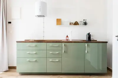 a kitchen with green cabinets and a counter top at Cozy modern studio in Prague's absolute center in Prague