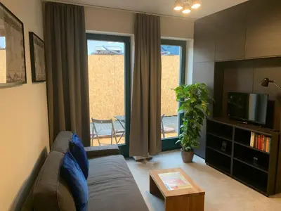 a living room with a couch and a tv at Cozy friendly place with free parking in Prague