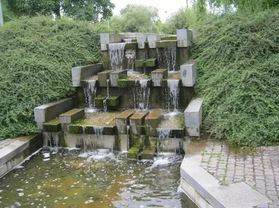 a waterfall in the middle of a pond at Cozy friendly place with free parking in Prague