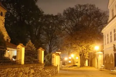 a city street at night with buildings and street lights at Cozy friendly place with free parking in Prague