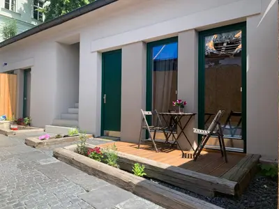 a house with two chairs on a wooden deck at Cozy friendly place with free parking in Prague