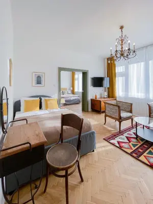 a bedroom with a large bed and a living room at TurnKey I Vintage Terrace Apartment in Prague
