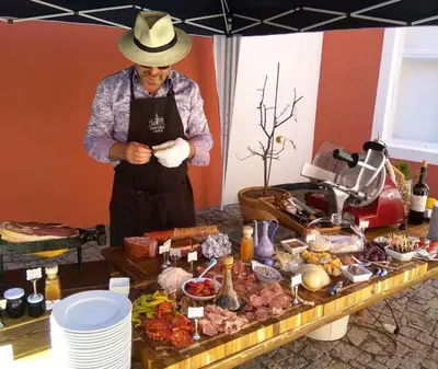 a man in a hat standing next to a table of food at Antonio Residence in Škvorec