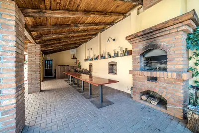 a brick room with a table and a brick fireplace at Antonio Residence in Škvorec
