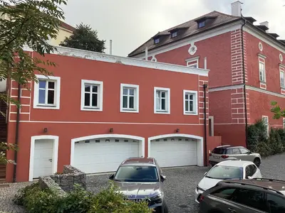a red building with cars parked in front of it at Antonio Residence in Škvorec