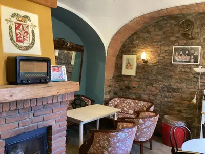 a living room with a fireplace and a tv at Antonio Residence in Škvorec