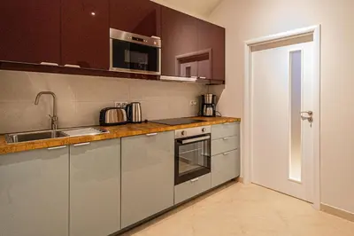 a kitchen with a sink and a stove top oven at Modern and Spacious Apartments in City Center in Prague