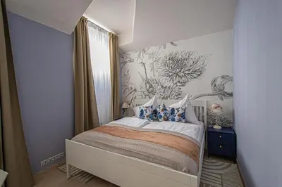 a bedroom with a bed with a flower mural on the wall at Modern and Spacious Apartments in City Center in Prague
