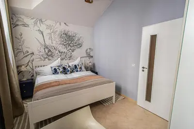 a bedroom with a bed with a flower wallpaper at Modern and Spacious Apartments in City Center in Prague