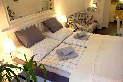 a living room with two beds and a couch at Balcony King Suite 12 min from Charles Bridge in Prague