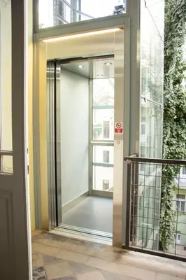 a glass door to a building with a balcony at Balcony King Suite 12 min from Charles Bridge in Prague
