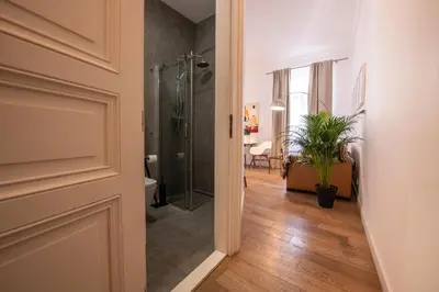 a bathroom with a shower and a toilet and a plant at Modern Downtown APT - renovated, on ideal location in Prague