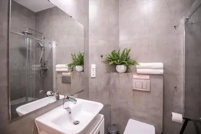 a bathroom with a sink and a shower with plants at Modern Downtown APT - renovated, on ideal location in Prague