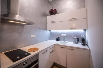 a small kitchen with white cabinets and a sink at Modern Downtown APT - renovated, on ideal location in Prague