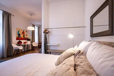 a bedroom with a white bed and a table at Modern Downtown APT - renovated, on ideal location in Prague