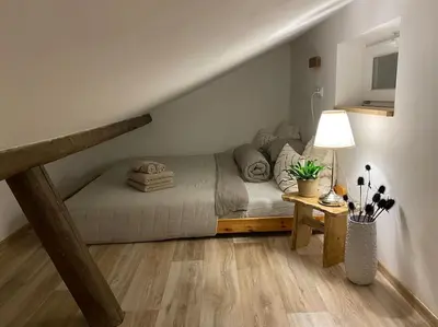 a bedroom with a bed and a table with a lamp at Garden House in Roudnice nad Labem