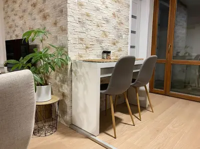 a kitchen with two chairs and a island in a room at Garden House in Roudnice nad Labem