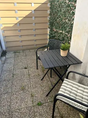 a picnic table and a bench with a potted plant at Garden House in Roudnice nad Labem