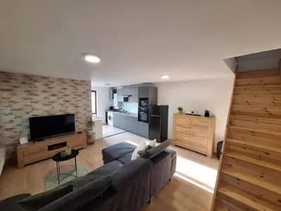 a living room with a couch and a tv at Garden House in Roudnice nad Labem