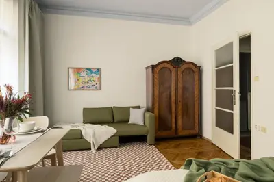 a living room with a couch and a table at Old Town Konviktská - Bohemian Residence in Prague