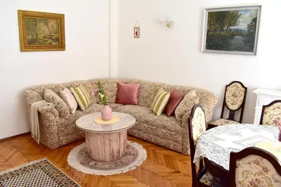 a living room with a couch and a table at Old Town Konviktská - Bohemian Residence in Prague