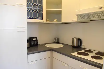 a small kitchen with a sink and a stove at Old Town Konviktská - Bohemian Residence in Prague