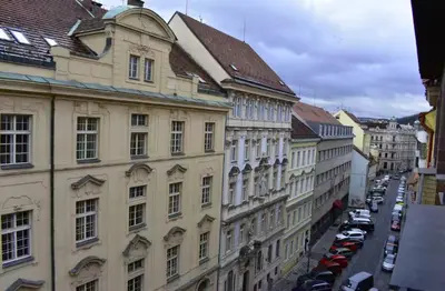 a view of a city street with buildings and cars at Old Town Konviktská - Bohemian Residence in Prague