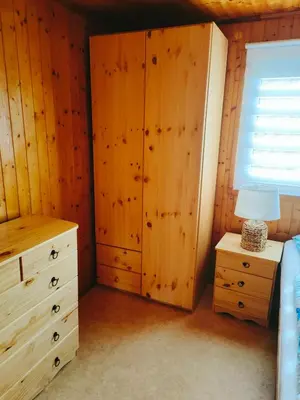a bedroom with a bed and a dresser and a window at Chata Slapy - Ždáň in Slapy