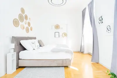 a white bedroom with a bed and a rug at Prague Days - Two-bedroom Apartment with Workspace right next to Old Town Square in Prague